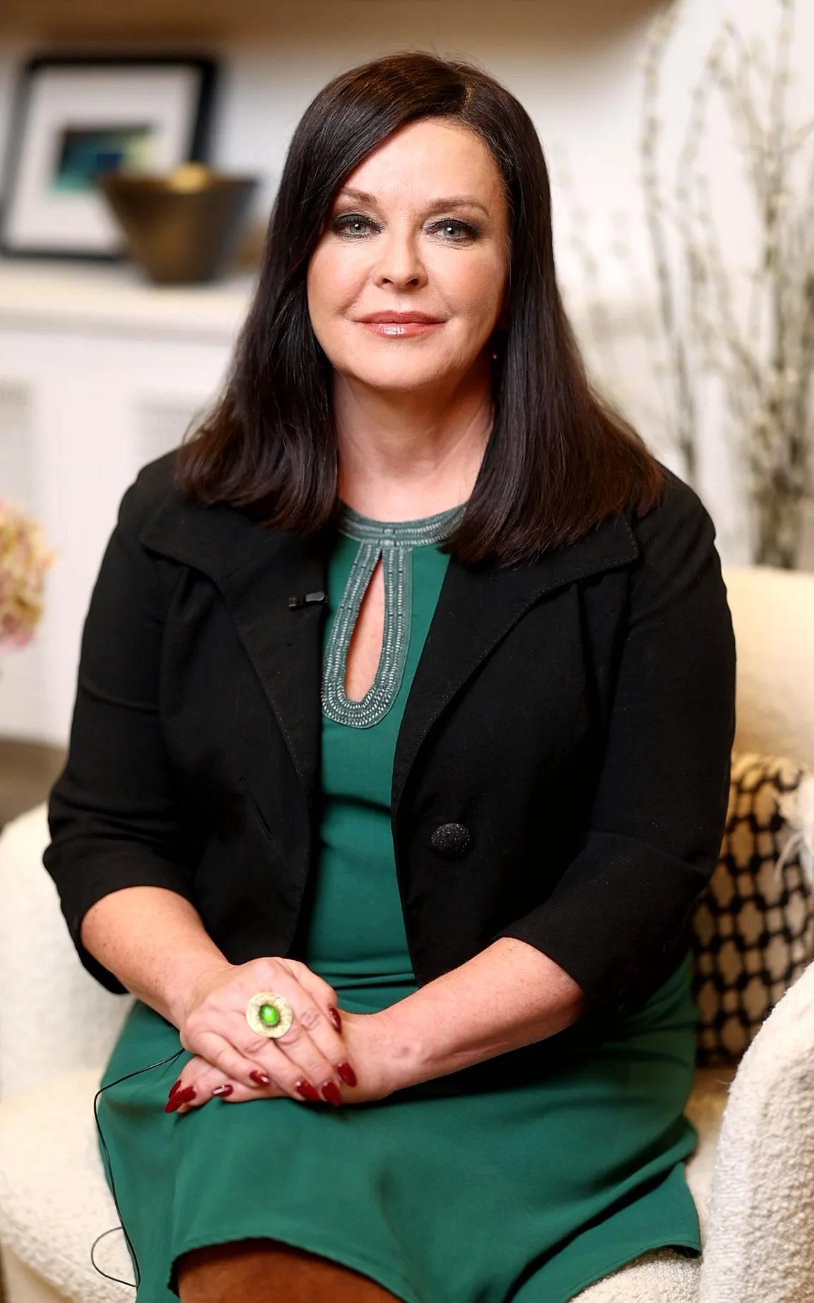 Karen Goslin, psychotherapist and author of Yellow Paint Learning to Live Again, smiling at office, full length